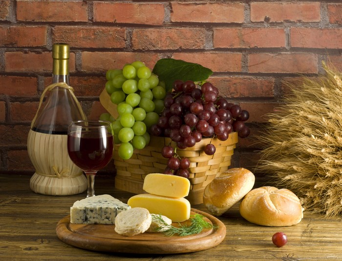 Still-life with wine, grapes, cheese, and bread