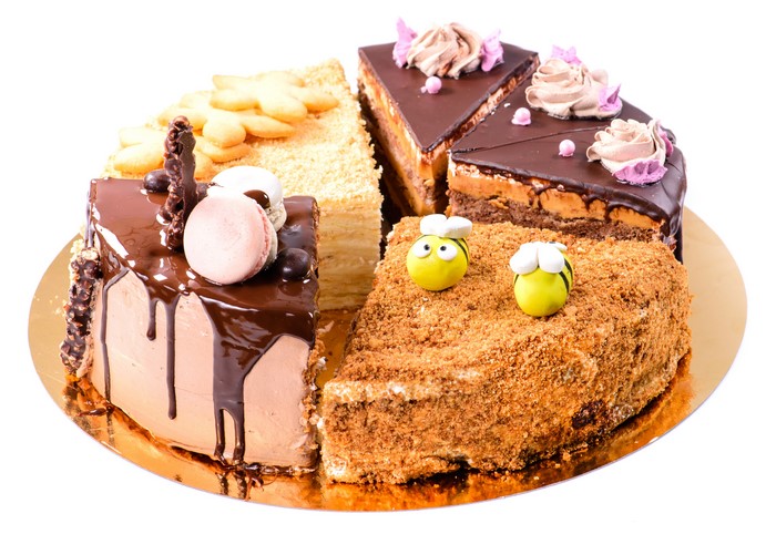 Assortment of decorated cakes on a white background