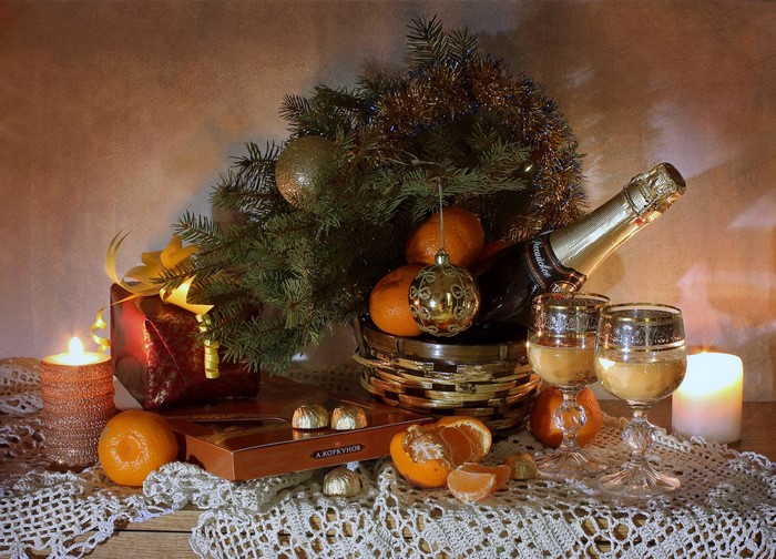 Christmas still-life with champagne, mandarins, and gifts