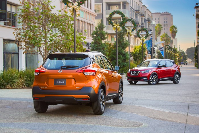 Two Nissan Kicks cars on a street
