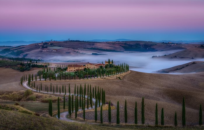 Tuscan landscape with winding road and cypress trees