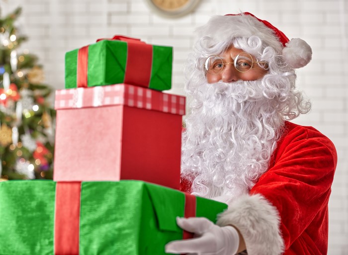 Santa Claus holding Christmas gifts