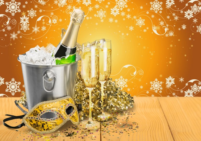 Champagne bottle and glasses with mask and snowflakes