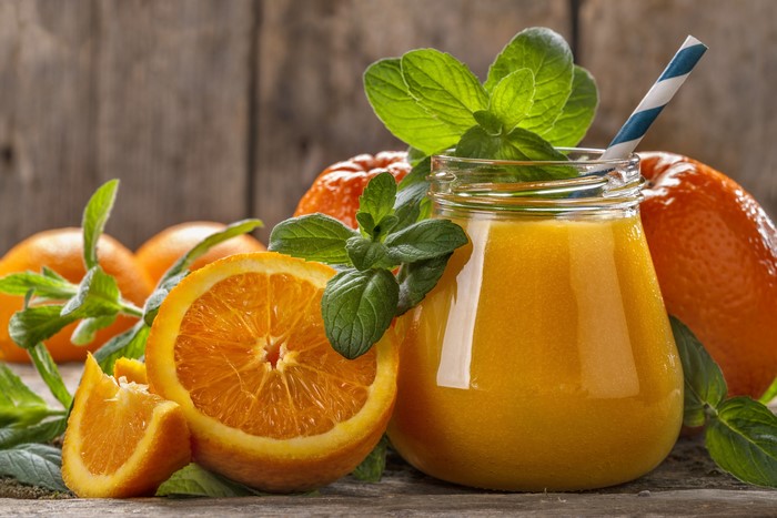Orange Juice in a Jar with Oranges and Mint