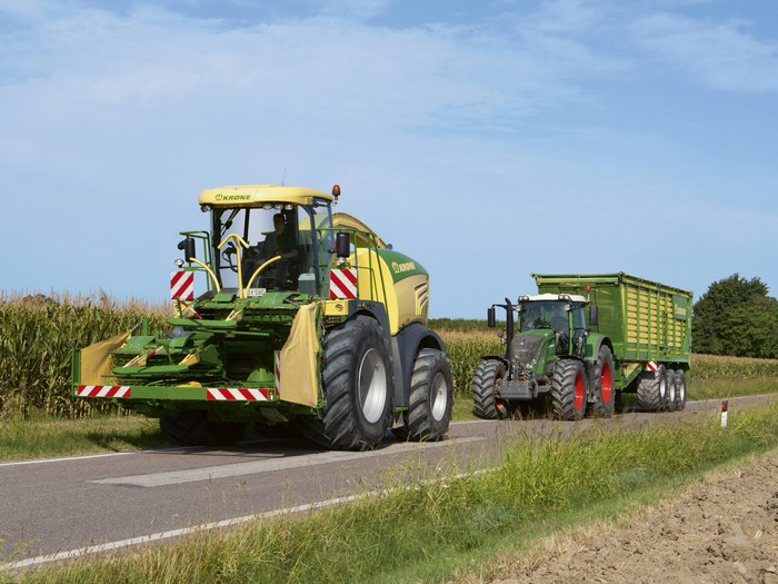 Krone BiG X 580 and Fendt tractor with trailer on road