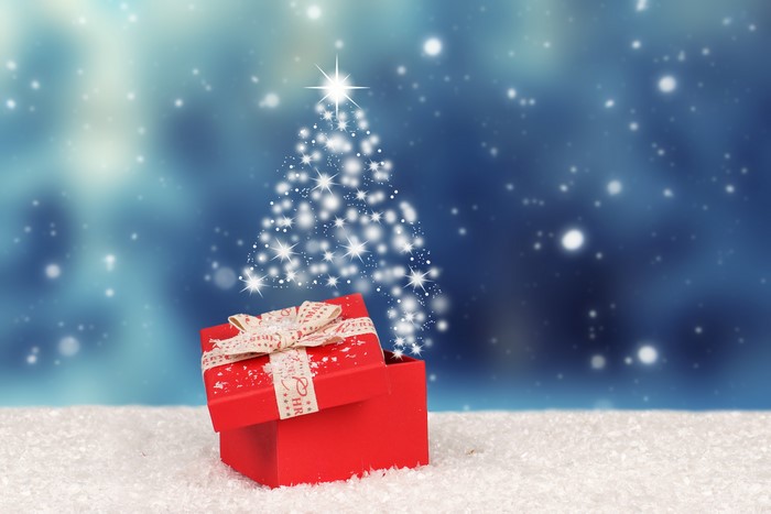 Christmas gift box with sparkling tree and snow