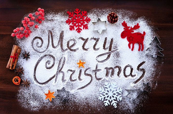 Merry Christmas written in powdered sugar with decorations