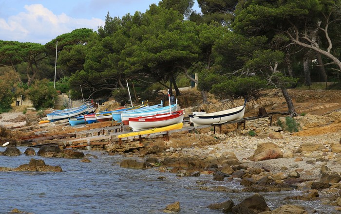 Boats on a rocky shore with pine trees in France