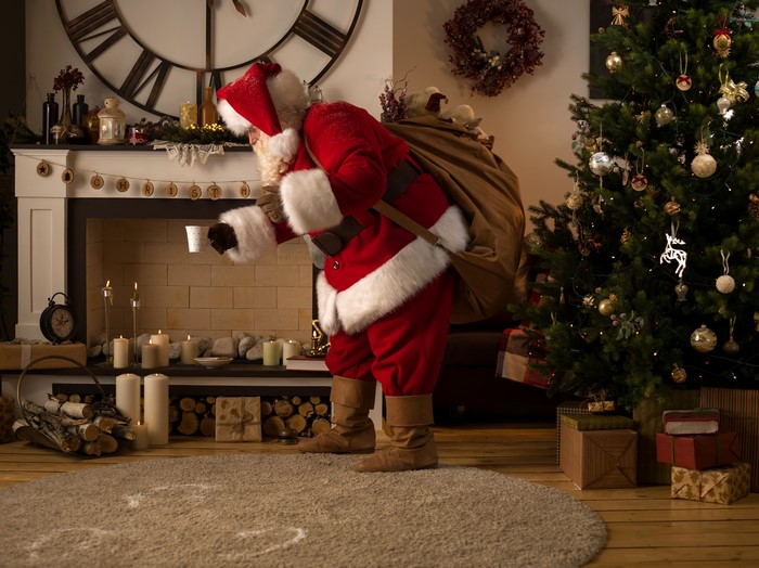 Santa Claus Near Fireplace With Christmas Tree 4K