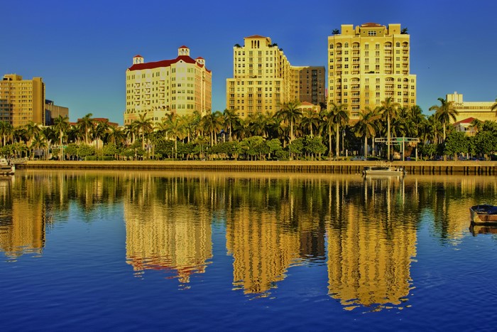 Buildings and palm trees reflected in water in Florida