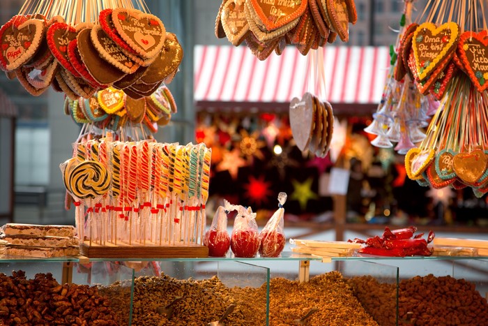 Christmas market stall with gingerbread hearts and lollipops