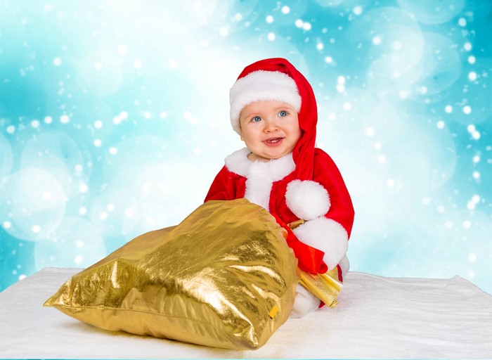 Baby in Santa costume with gift bag