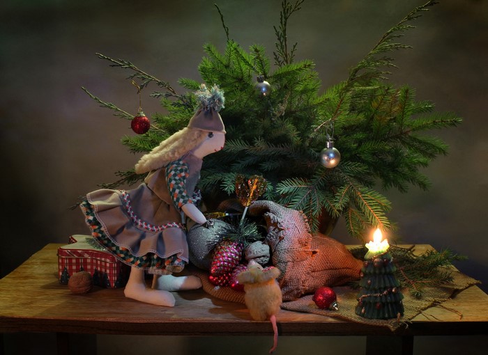 Christmas still-life with doll, mouse, and candle