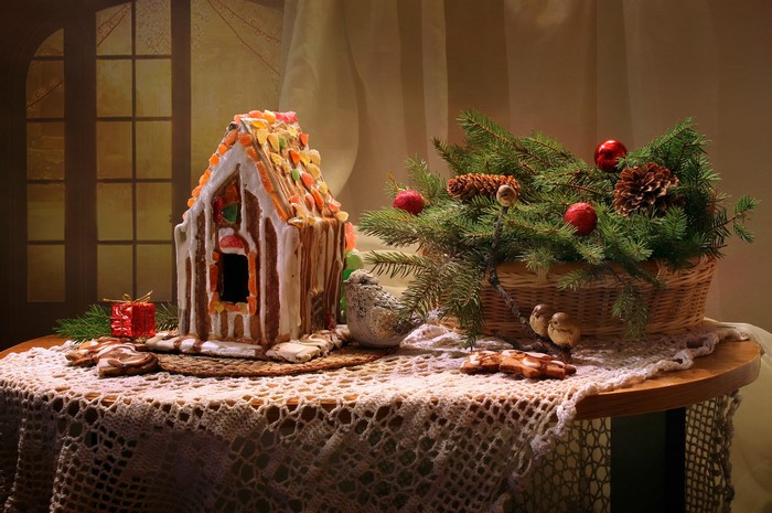 Christmas still life with gingerbread house and pine branches