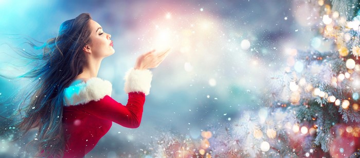 Woman in Santa Costume Blowing Glitter
