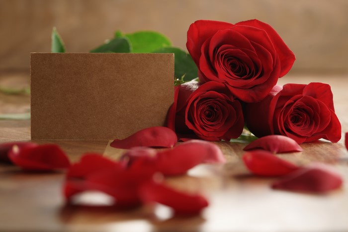 Three Red Roses with Card and Petals
