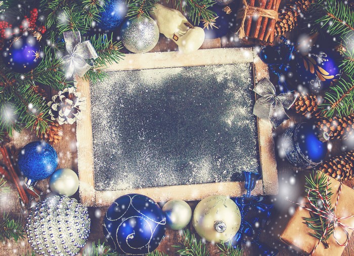 Christmas balls and pine cones on a chalkboard template