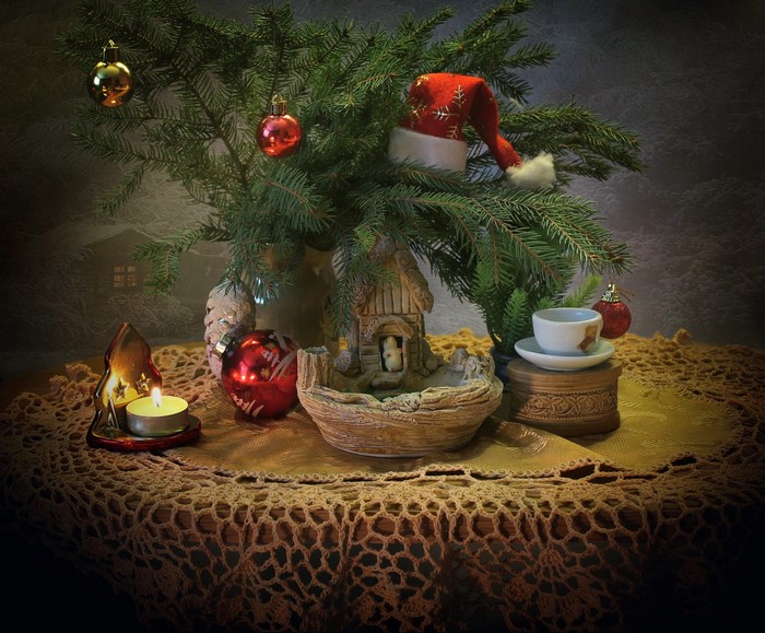 Christmas still life with fir branches, ornaments, and candle