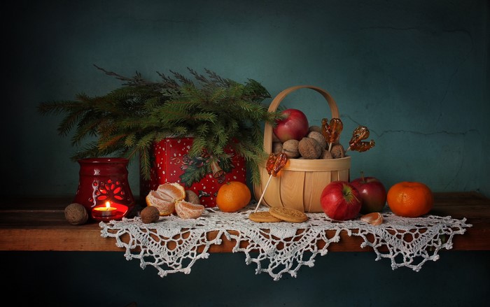 Christmas still-life with fruits, nuts, and candle