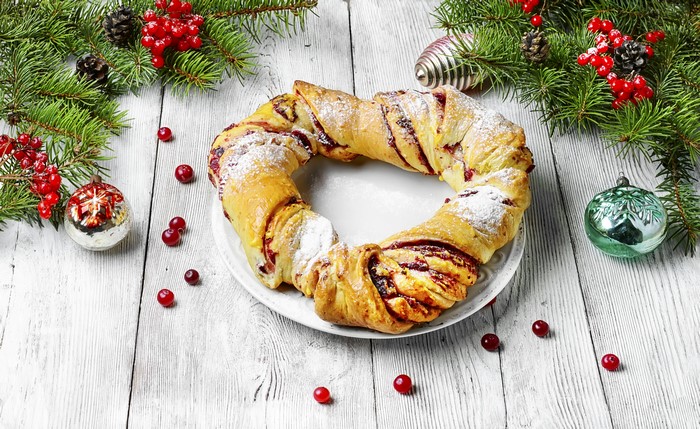 Christmas wreath pastry with cranberries and pine branches