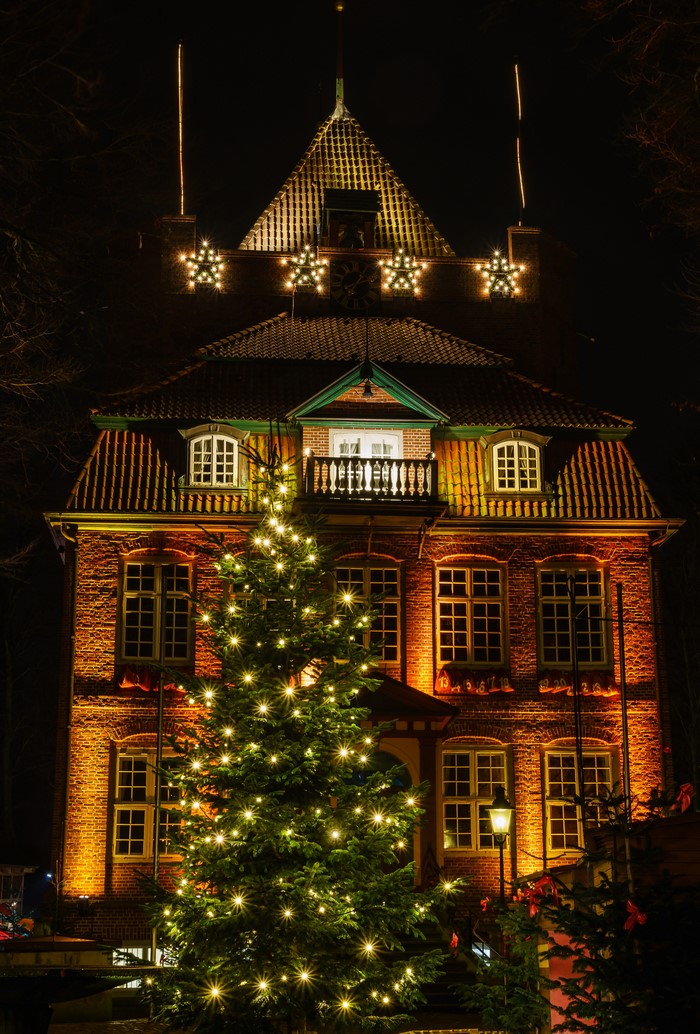 Christmas decorations on a brick building at night