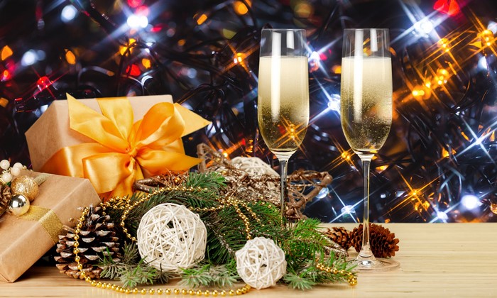 Champagne glasses with Christmas gifts and decorations