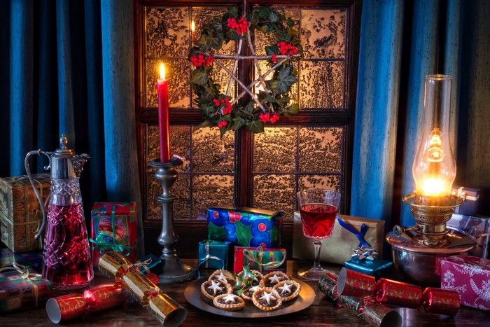 Christmas still-life with gifts, candle, and wine