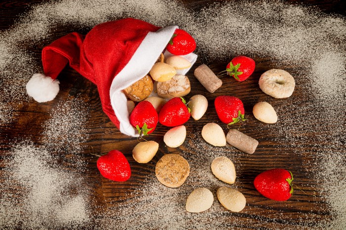Christmas Santa hat with strawberries and cookies