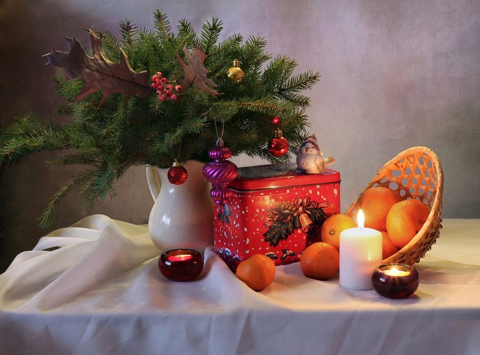 Christmas still-life with fir branches, mandarins, and candles