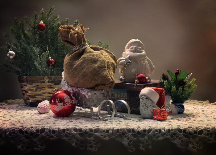 Christmas still-life with tree, gifts, and Santa figurine
