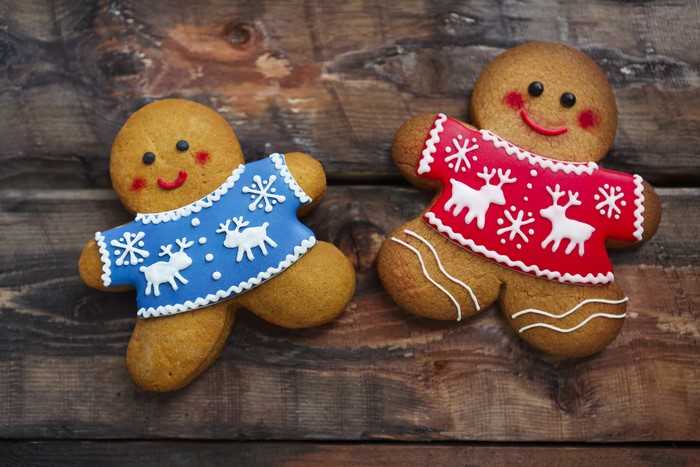 Two Christmas gingerbread cookies on wood