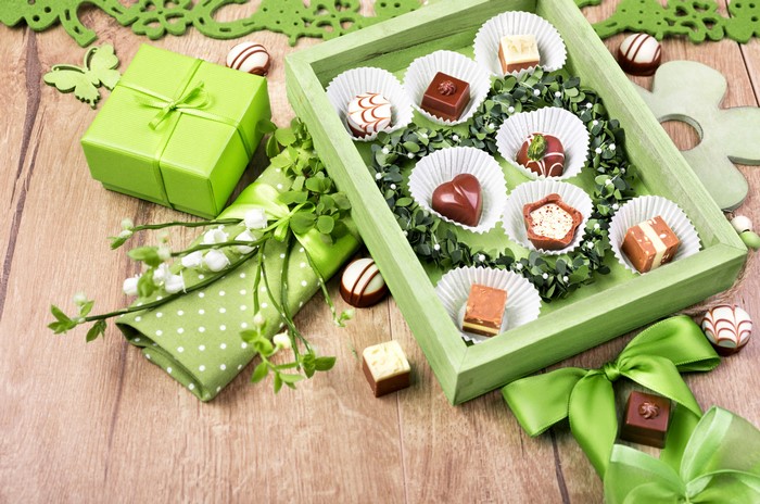 Box of assorted chocolates with green gift box and decorations