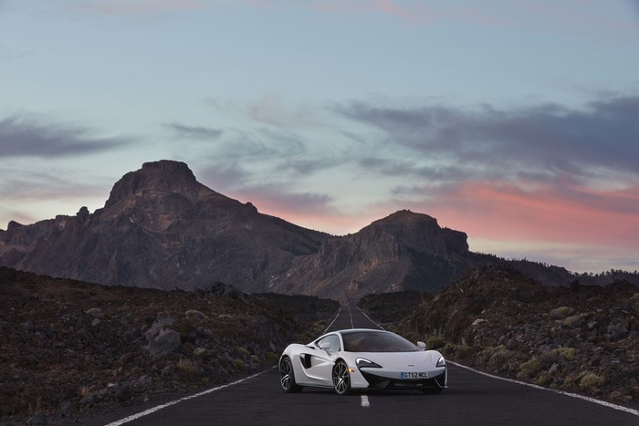 White McLaren 570GT on a mountain road