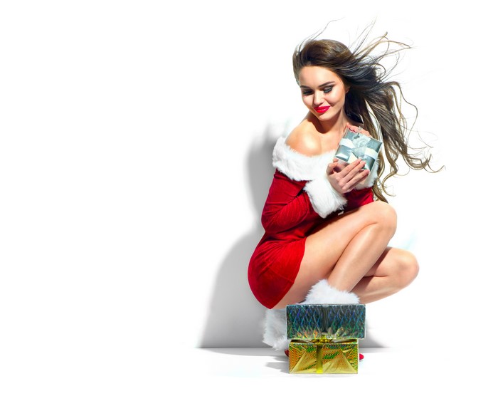 Woman in Santa costume with Christmas gifts