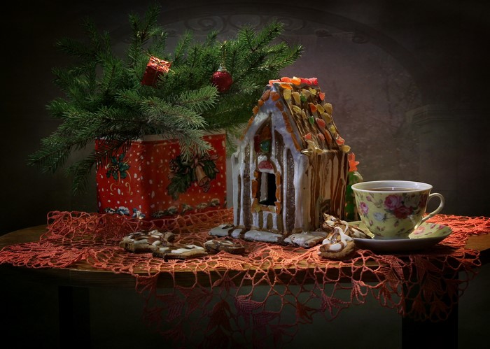 Christmas still-life with gingerbread house and tea