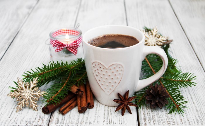 Christmas coffee with cinnamon and fir branches
