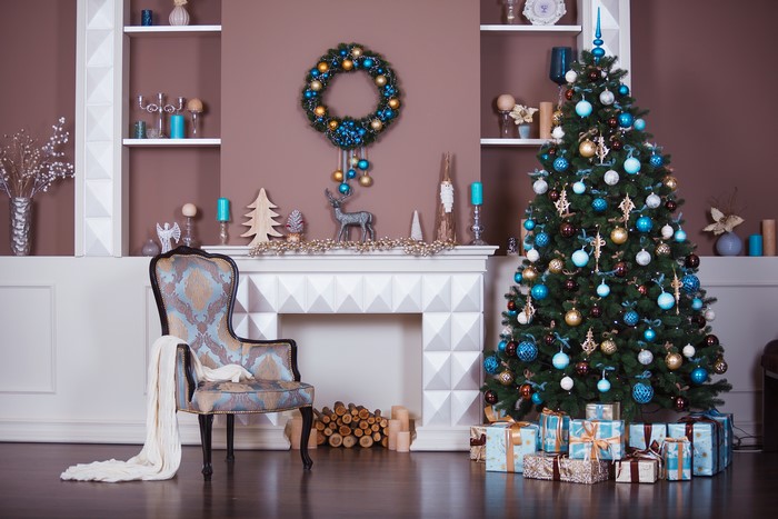 Christmas interior with tree, gifts, and chair