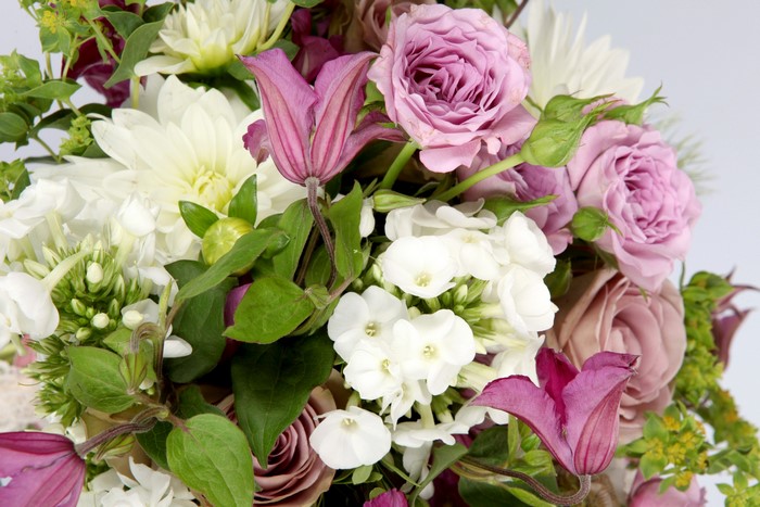Bouquet of pink roses, white dahlias, and purple clematis