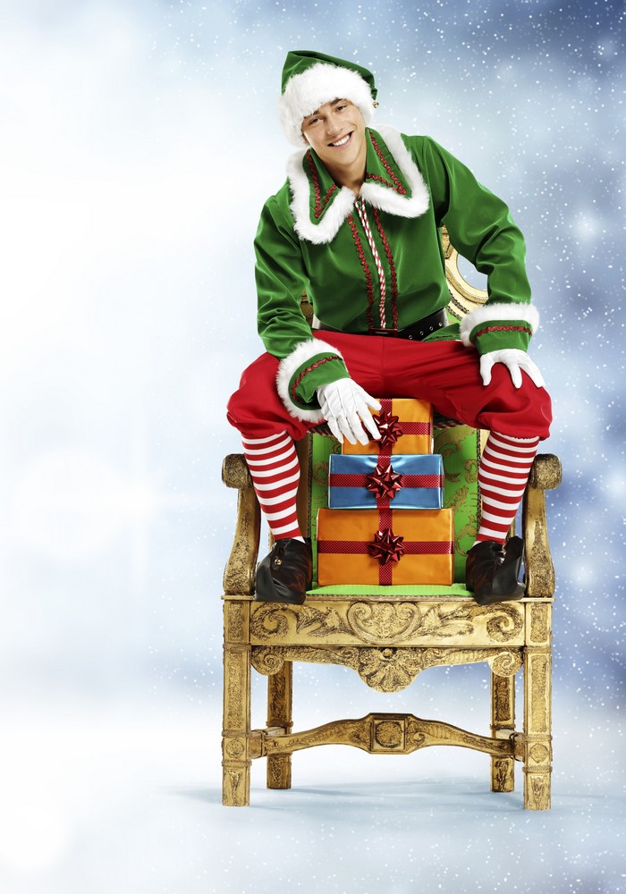 Elf sitting on a chair with gifts