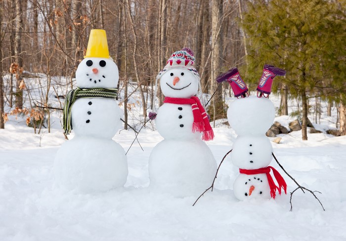 Three snowmen in a snowy forest