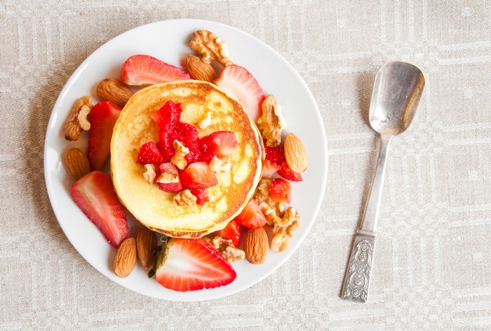Pancakes with Strawberries, Nuts, and a Spoon