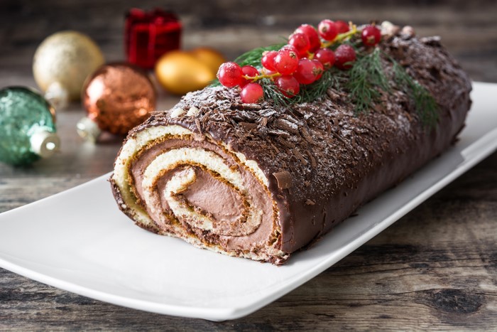 Chocolate Swiss Roll with Berries and Christmas Decorations