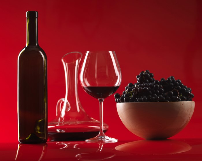 Wine bottle, decanter, wine glass, and grapes