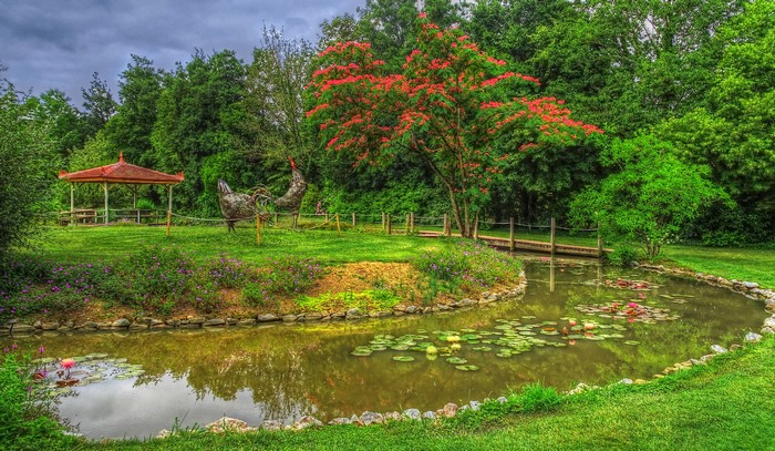 Park with pond, gazebo, and bird sculptures