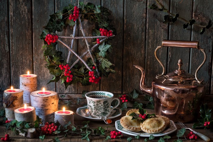 Christmas still life with kettle, candles, and mince pies