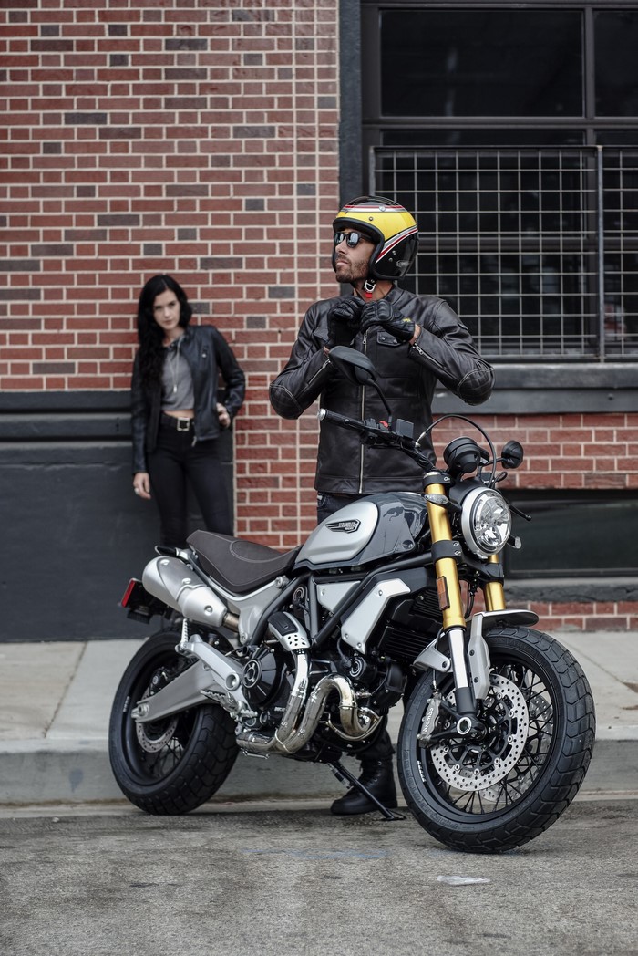 Man in helmet and woman with Ducati Scrambler 1100 Special