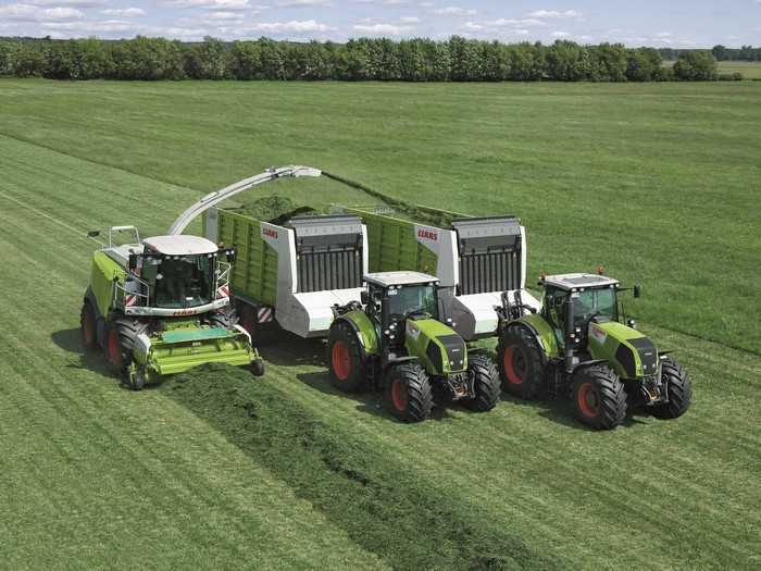 Claas agricultural machinery harvesting a field
