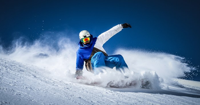 Man snowboarding down a snowy slope