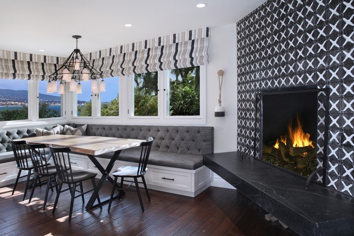 Dining area with banquette seating and fireplace