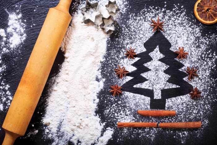 Christmas baking ingredients with rolling pin and cookie cutters